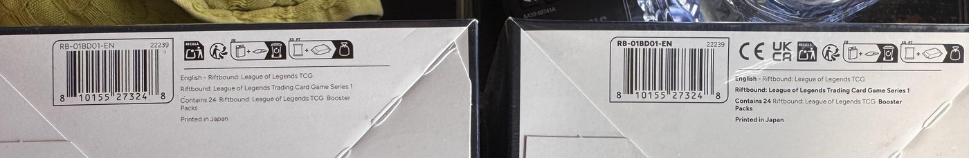 Fondo di due box Origins fotografati a gennaio 2026: ristampa a sinistra, prima wave con CE e UKCA a destra